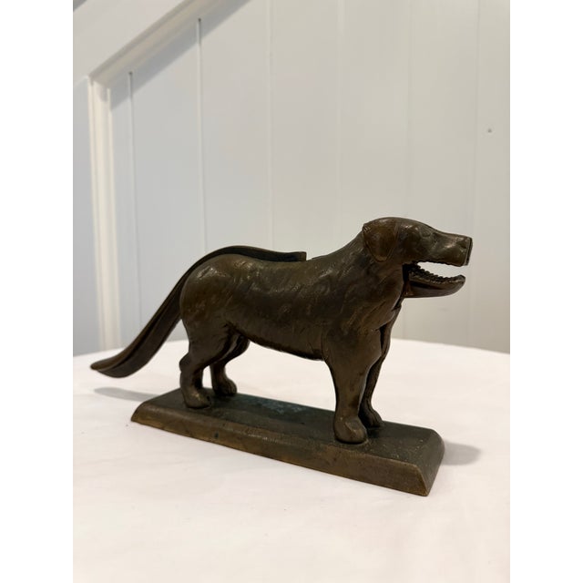 A wonderful antique American cast iron figural dog nutcracker dating to the early 20th century, featuring a beautifully...