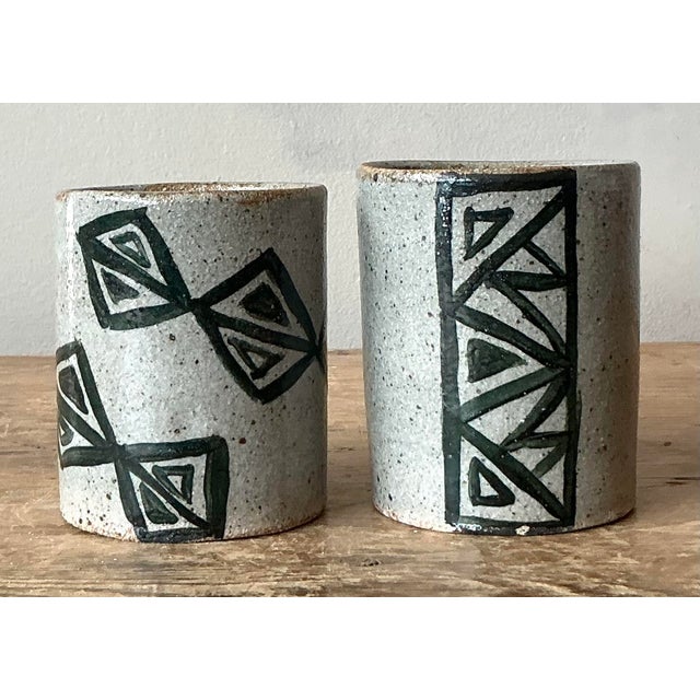 This compelling pair of vintage studio pottery tumblers embodies the earthy, artisanal aesthetic popular during the Mid-...