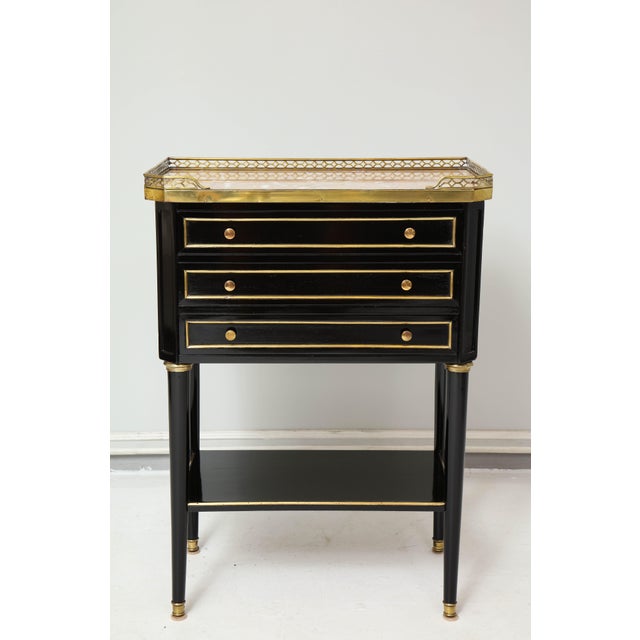 Pair of French Louis XVI style marble-top end tables/nightstands with brass gallery.