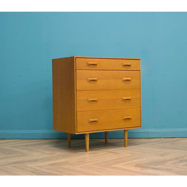 A mid century oak chest of drawers by G Plan from the Brandon range, circa 1960s. Featuring four drawers This piece has an...
