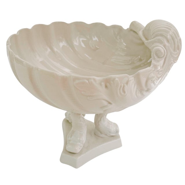 A beautiful mid-century Italian whiteware centerpiece bowl featuring a scalloped clam shell bowl anchored by three...