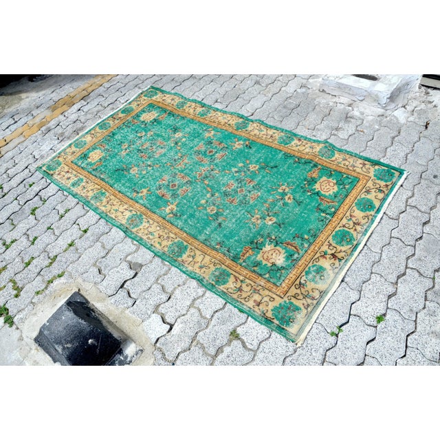 This is a vintage Turkish Oushak rug from the 1960s. The piece was hand-knotted.