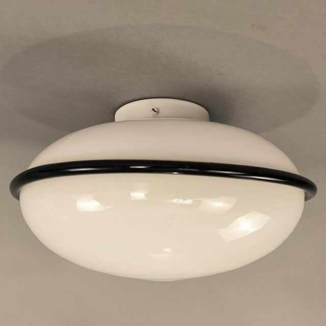 Vintage round ceiling light with a 1970s design. The structure is made of white Murano glass with an amethyst glass edge....