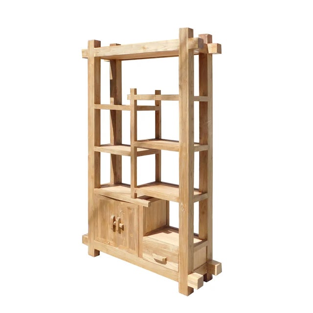 This is a display cabinet made of natural raw wood. It has an uneven shelves for display or for books. A drawer and a...