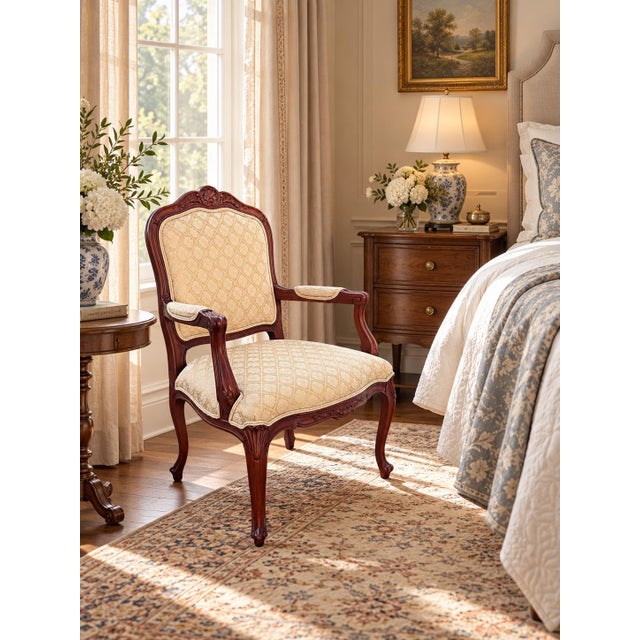 Refined Ethan Allen carved wood armchair featuring a graceful French-inspired frame with a shaped upholstered back,...
