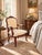 Refined Ethan Allen carved wood armchair featuring a graceful French-inspired frame with a shaped upholstered back,...
