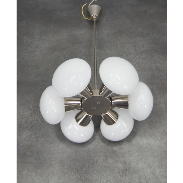 This Sputnik chandelier was made by Kamenický Šenov in Czechoslovakia in the 1960s. The lamp carries its original...