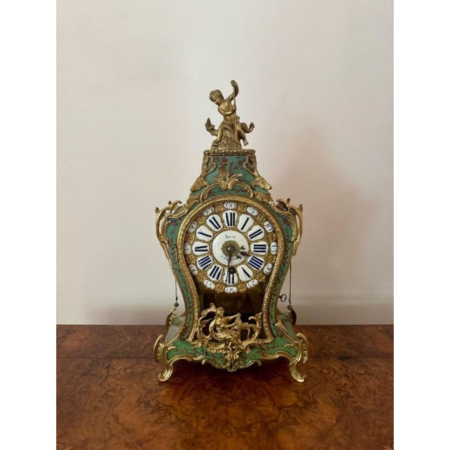 Fine quality antique 19th Century French ormolu mantle clock, having a fine quality antique French Rococo style mantle...