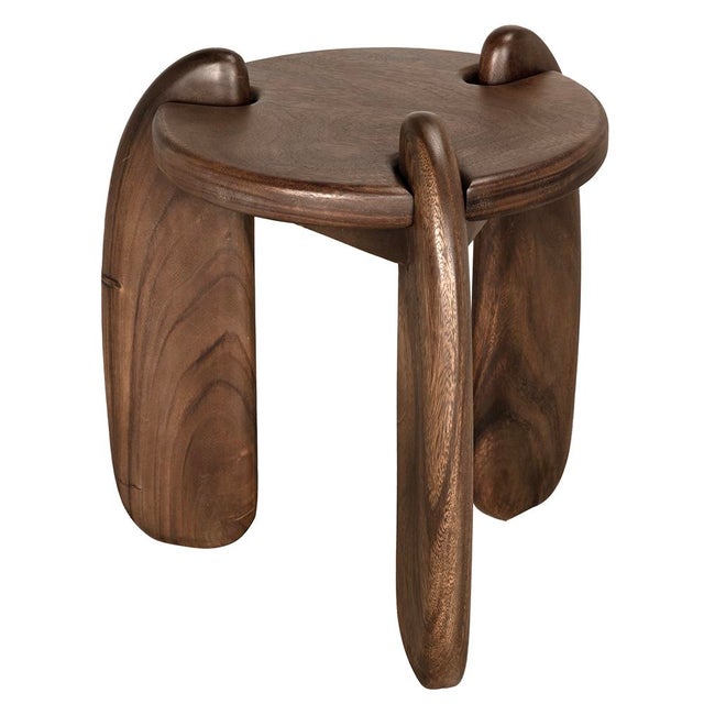 This sculptural teak side table features a rich finish and playful, oversized looped legs that extend through the top...