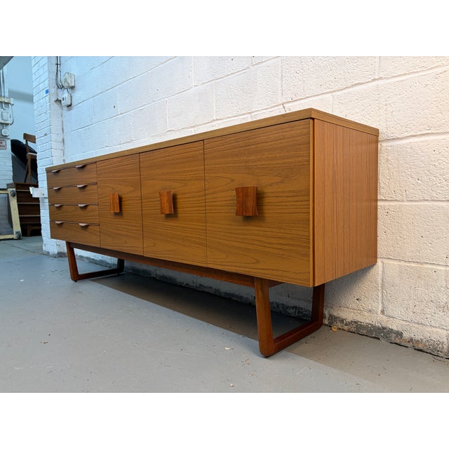 Mid-Century Teak Server by Europa, a perfect blend of timeless design and functional craftsmanship. Expertly constructed...