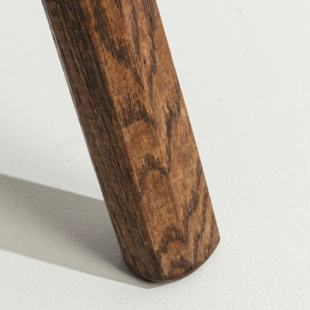 A 20th century oak stool designed in the Brutalist style, featuring a solid construction and bold, geometric form. The...