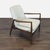 This Four Hands lounge chair features a sturdy dark wood frame with sleek, angled arms and legs. The chair is upholstered...