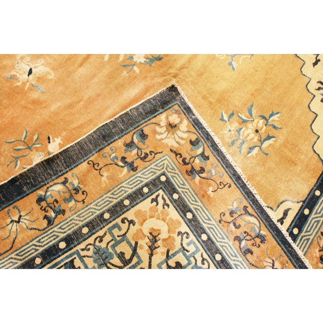 Originating from china in 1910, this antique peking rug enjoys a rich and varied combination of ornate colourways with art...