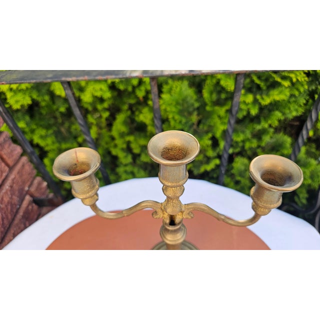 Art Deco / 1950s brass three-arm candlestick, dimensions: height 27.5 cm, width 24.2 cm, bottom diameter 11 cm.