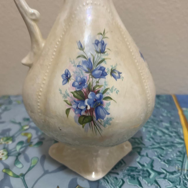 Add a touch of Victorian-inspired charm to your home with this beautiful vintage ceramic pitcher. This piece features a...