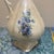 Add a touch of Victorian-inspired charm to your home with this beautiful vintage ceramic pitcher. This piece features a...