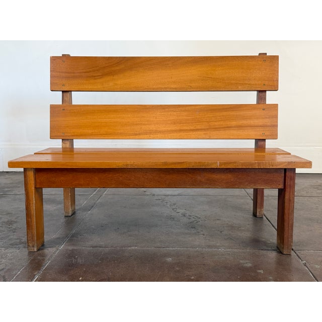 Vintage French bench from the 1950s, crafted in solid mahogany and brass hardware designed in a bold Brutalist style....