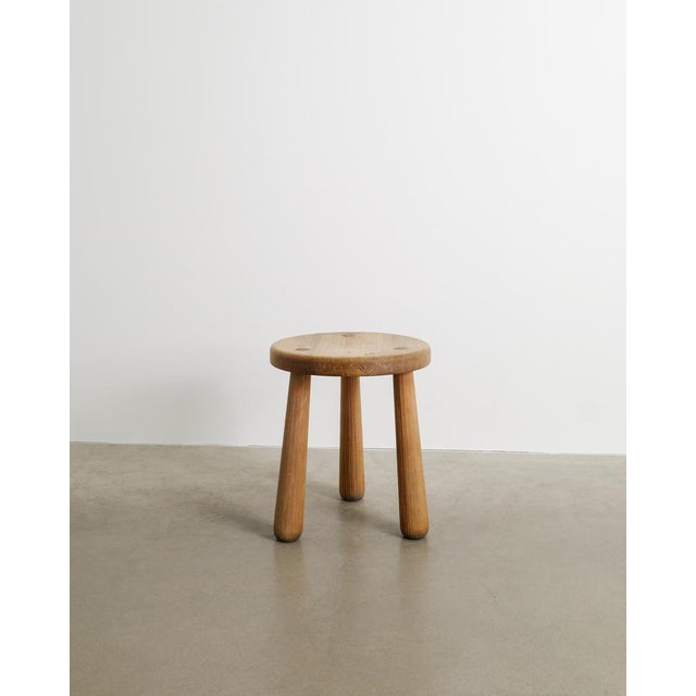 A rare and iconic Swedish modern tripod "Skoga" pine wooden stool by Axel Einar Hjorth produced by Nordiska Kompaniet...