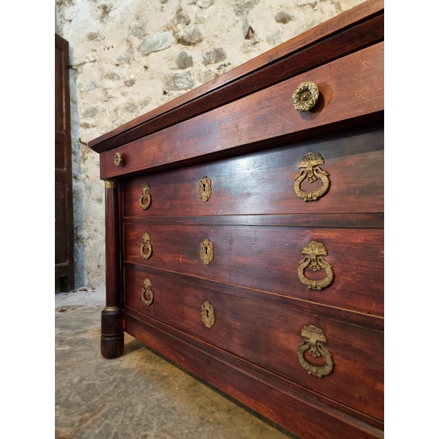 This antique French Empire chest of drawers dates from the early 19th century (circa 1800–1830) and is a fine example of...