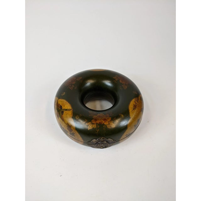 This “donut” box was used to hold a Mandarin court officials head necklace. Beautifully painted with floral motif