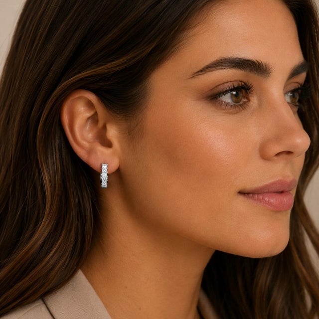 18k White gold hoop earrings set with princess cut white diamonds weighing 1.26 carats. 4.49g