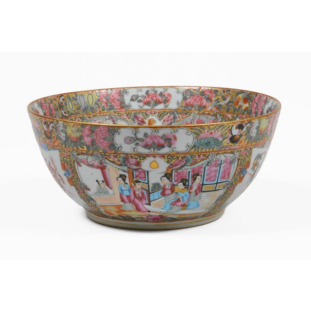 Antique Chinese porcelain punch bowl in the Rose Medallion color palette of pinks, greens, blue with gilding and having...
