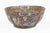 Antique Chinese porcelain punch bowl in the Rose Medallion color palette of pinks, greens, blue with gilding and having...