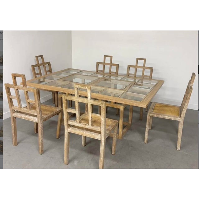 A very beautiful and rare dining room set. Six cane chairs and a large wood and glass table. High-quality production from...