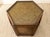 A handsome vintage side table with a geometric hexagonal silhouette and warm, richly grained wood construction. The inset...