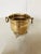 Polished footed brass cachepot with round knocker handles. Measures 6” Diameter x 5.75”H.