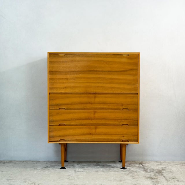A Hilleplan bureau by Robin Day for Hille: a fall-front desk and a chest of drawers in one compact cabinet. The top flap...
