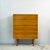 A Hilleplan bureau by Robin Day for Hille: a fall-front desk and a chest of drawers in one compact cabinet. The top flap...