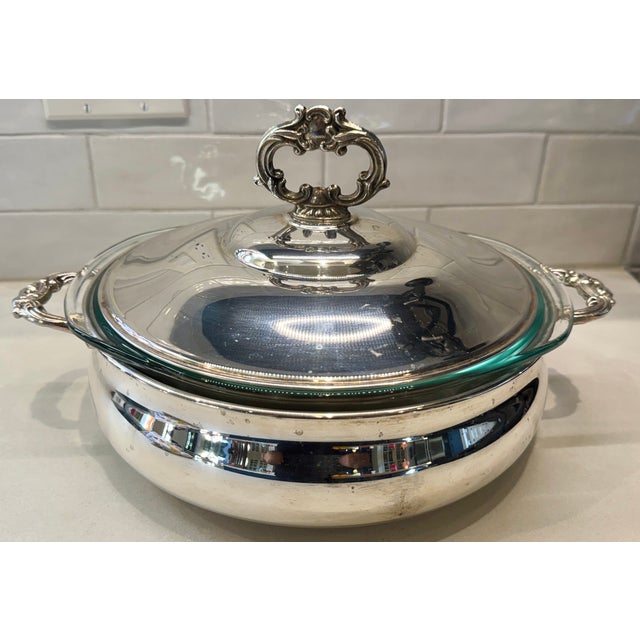 Elegant vintage silverplate casserole/serving dish with ornate lid and side handles, made by M&R English Silver Mfg Co. It...