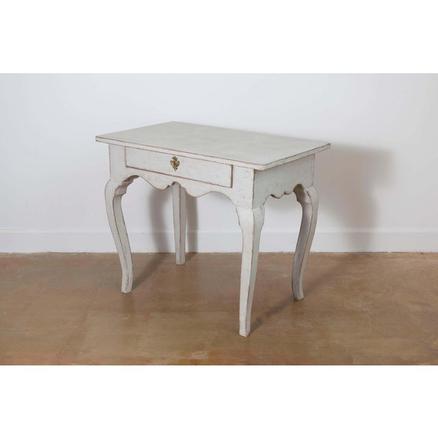 This charming 19th-century Swedish side table embodies the rustic elegance of Gustavian design. Crafted from solid wood,...