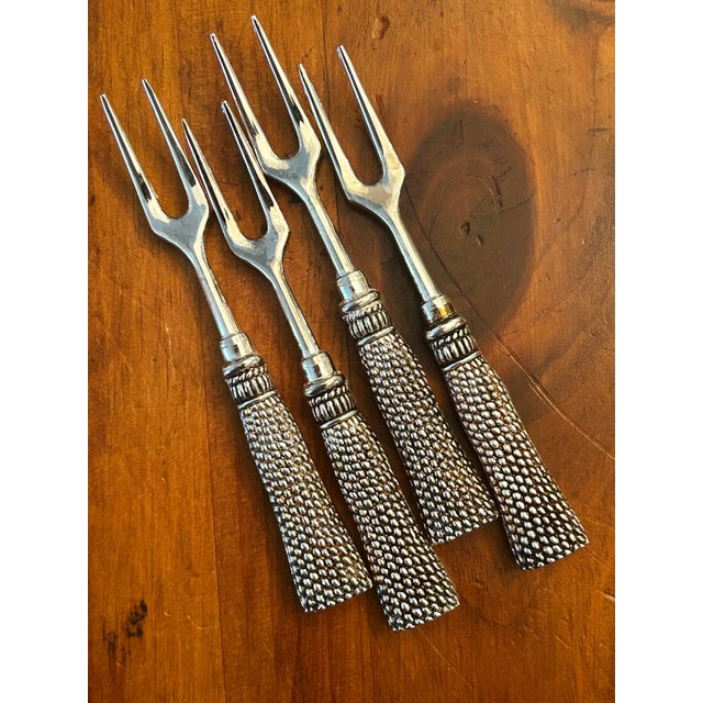 Add to your entertaining with this set of four vintage silver-plated charcuterie and cocktail forks by Silea. Featuring...