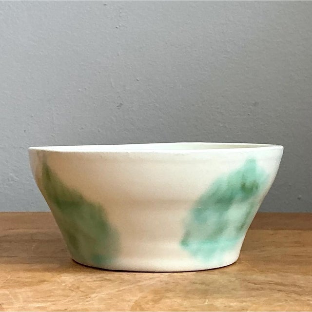 This bowl embraces a simple, gently flared silhouette, its walls angling outward from a narrower base to a wide, open rim...