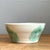 This bowl embraces a simple, gently flared silhouette, its walls angling outward from a narrower base to a wide, open rim...