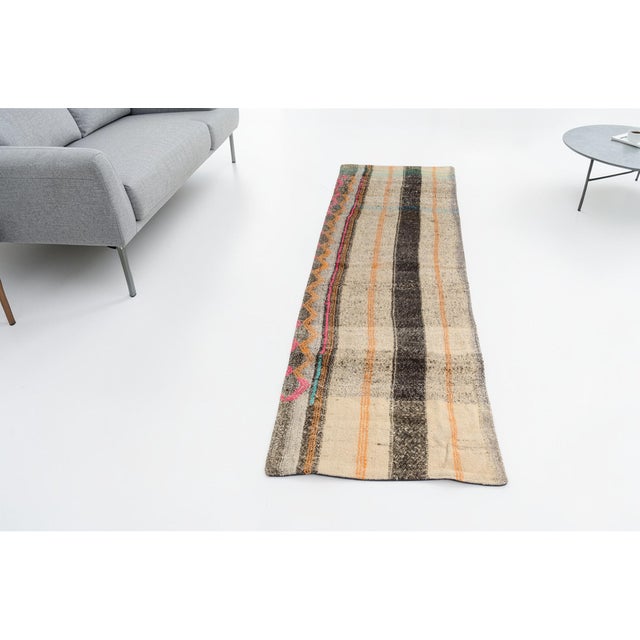 This is a vintage Turkish Oushak rug from the Mid 20th Century. The piece was hand-knotted.