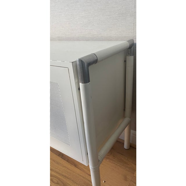 1950 Mid century modern white lacquer commode with canned door panels, chrome accents.