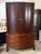 Design Plus Gallery presents a Dark Espresso Wood Media Armoire Cabinet. This two-door cabinet has an espresso-toned wood...