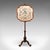 This is an antique pole screen. An English, rosewood and glass embroidered fireside heat reflector, dating to the early...