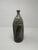 Unique mid-century ceramic vase with intricate carvings. A delicate white opaque glaze over a neutral base. Can be a...