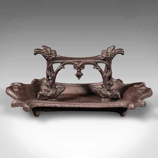 This is an antique ornate boot scraper. An English, cast iron doorway shoe pull, dating to the early Victorian period,...