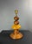 Lamp from the 1970s with a turned wooden base made of stacked, ribbed elements. The centre piece is a flattened disc of...