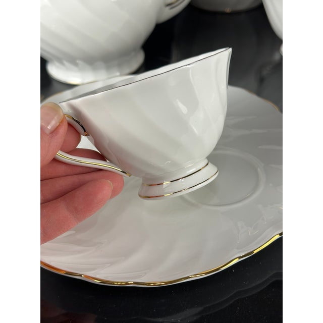 This elegant Royal Tuscan English bone china tea and coffee set is in the classic Dover pattern, dating to the 1960s. The...