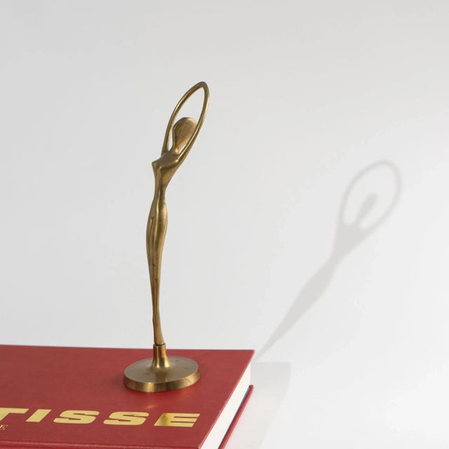Elegant vintage brass ballerina figurine, beautifully crafted and perfectly poised in a graceful dancing pose. This...