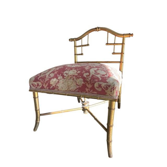 Crafted with meticulous attention to detail, the ottoman features an intricate gilded faux bamboo motif meticulously...