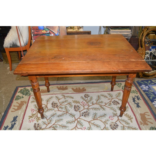 This is an antique English work table. Could be a small dining or side table. A rustic pine wood with turned legs. Single...