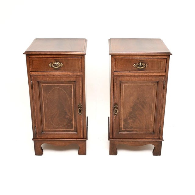 A wonderful pair of antique Edwardian inlaid bedside cabinets. They were made in England, they date from the 1900-1910...