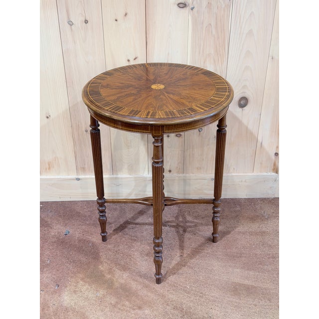 A distinguished vintage mahogany center table with beautifully executed inlay and an unmistakably English-inspired...